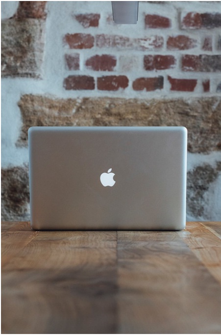 Macbook on brown wooden table