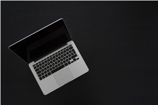 Macbook on black floor