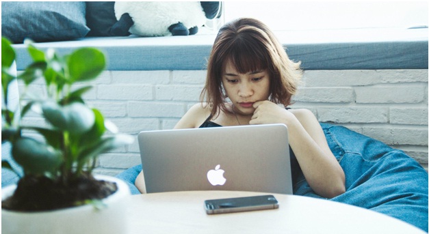 Woman on beanbag chair on her Macbook 